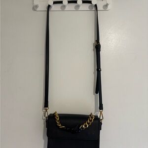 Sleek Black Crossbody Bag with Gold Chain Accent
